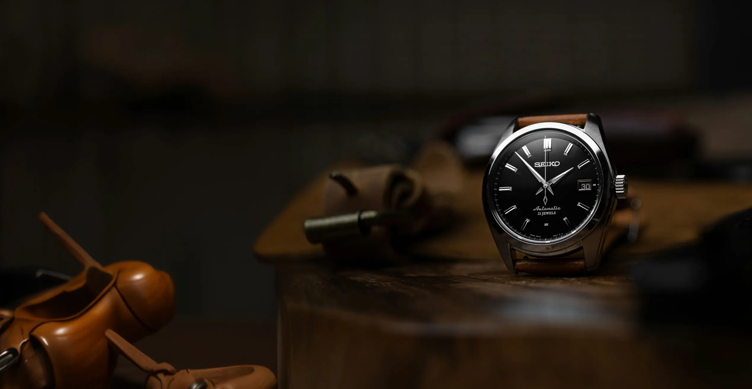 A wristwatch on a dark textured surface